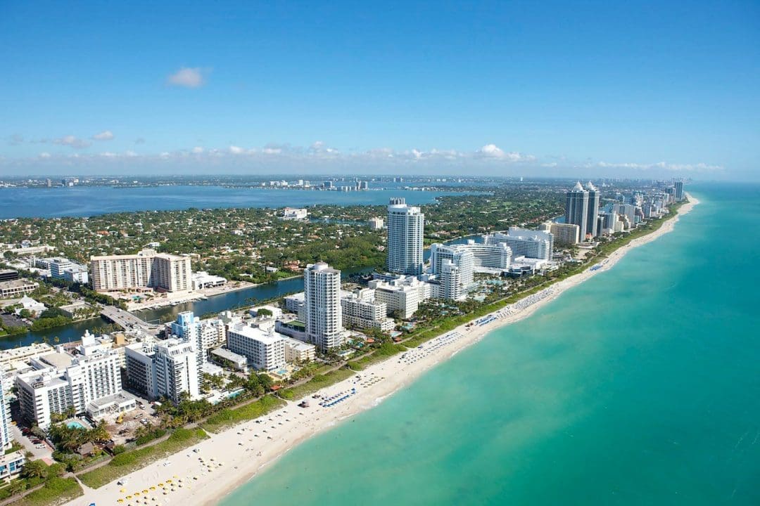An aerial view of the coastline and high-rise buildings in Miami Beach, Florida